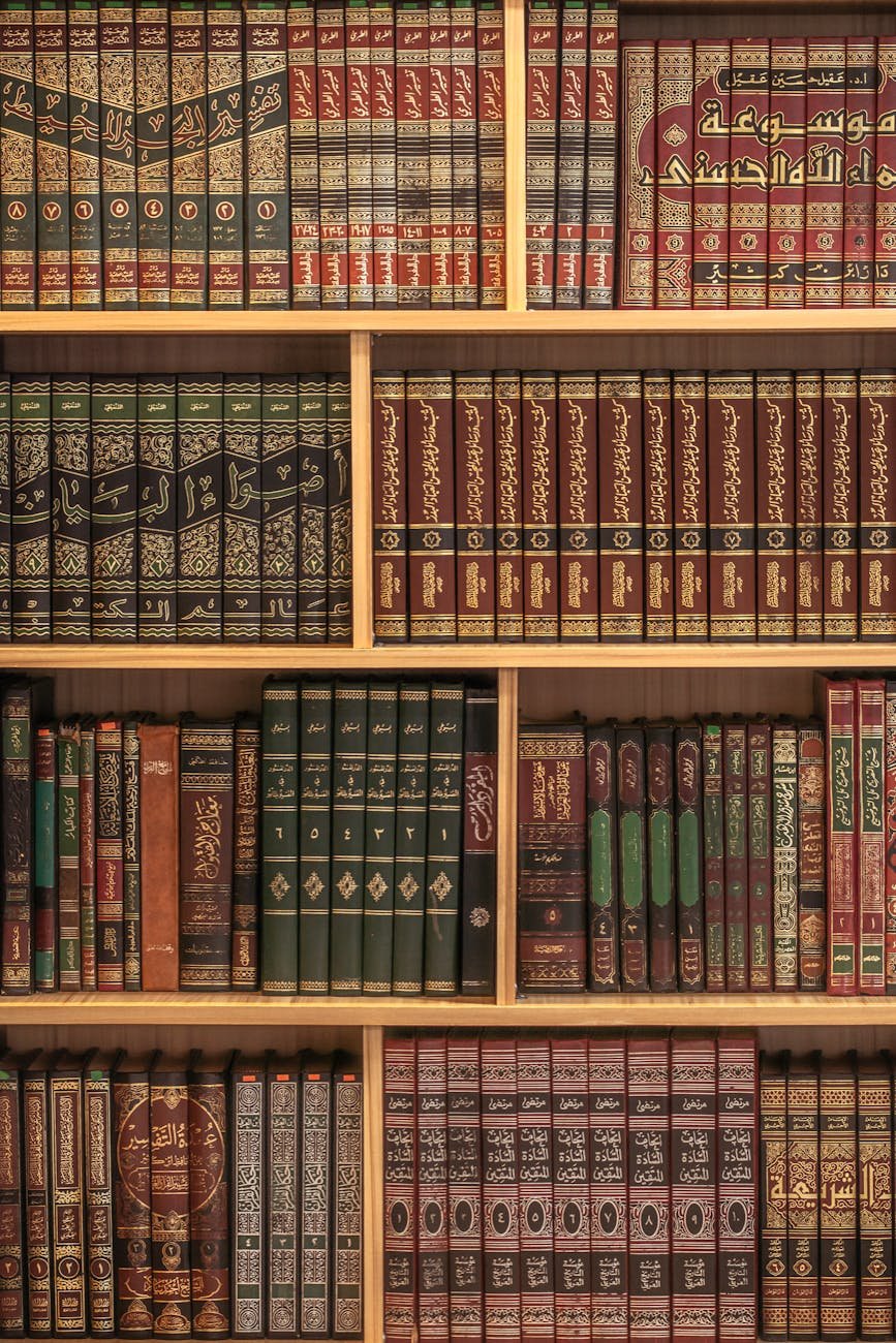 A collection of Islamic books neatly arranged on wooden shelves showcasing rich cultural heritage.