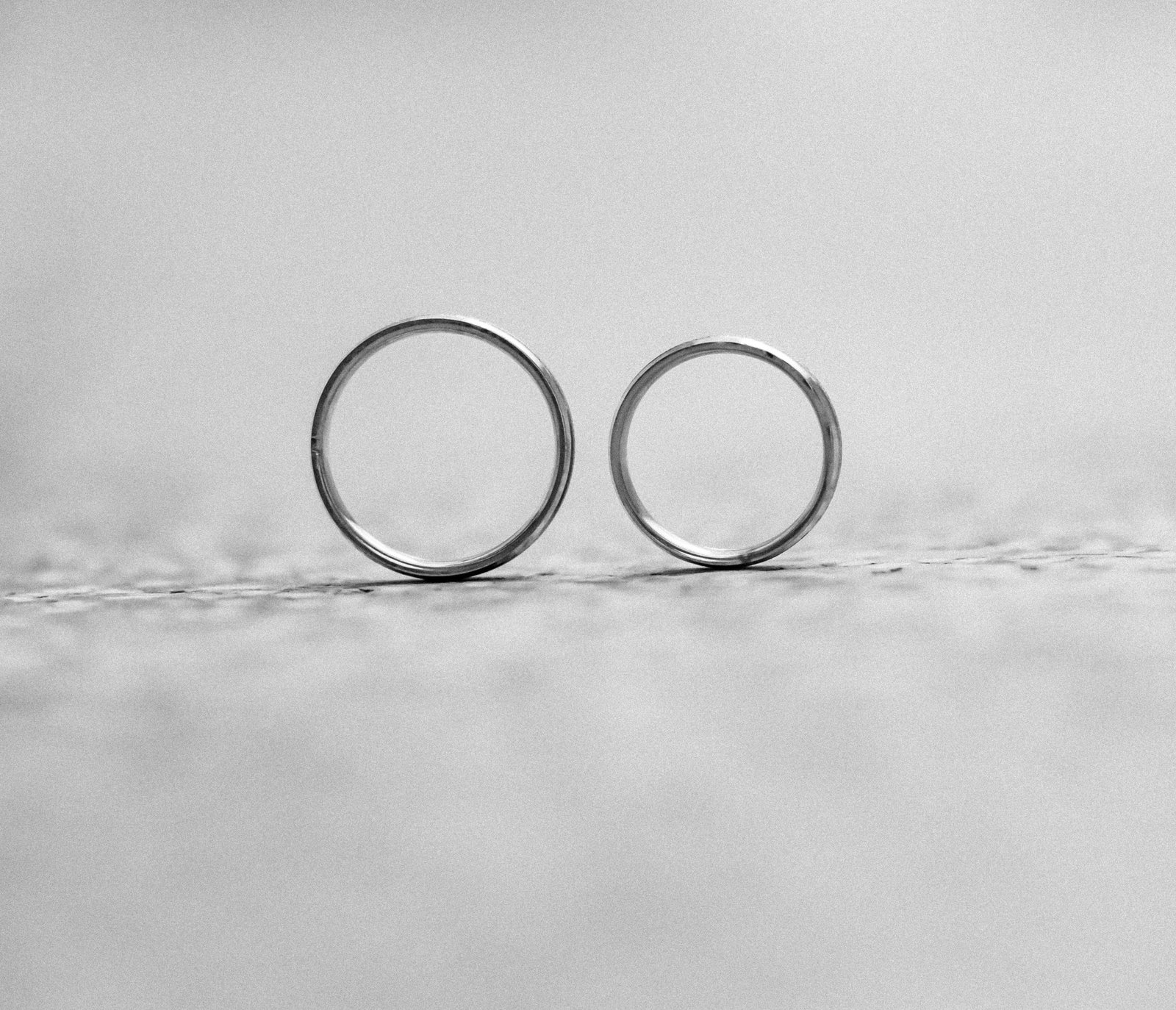 Artistic black and white photo of two wedding rings symbolizing love and marriage.