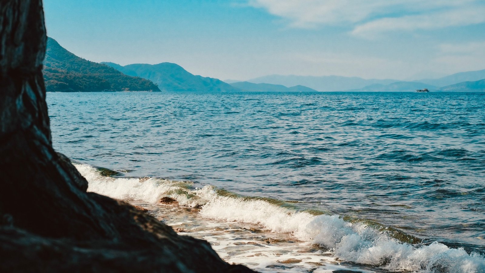 Captivating view of Aegean sea waves and distant mountains from Aydın, Türkiye.
